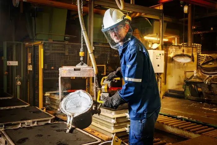 Worker operating lifting equipment in an industrial setting