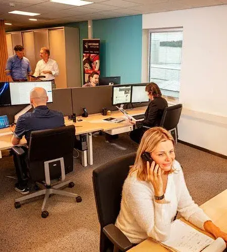 Sales team members working in an office with focus on customer service